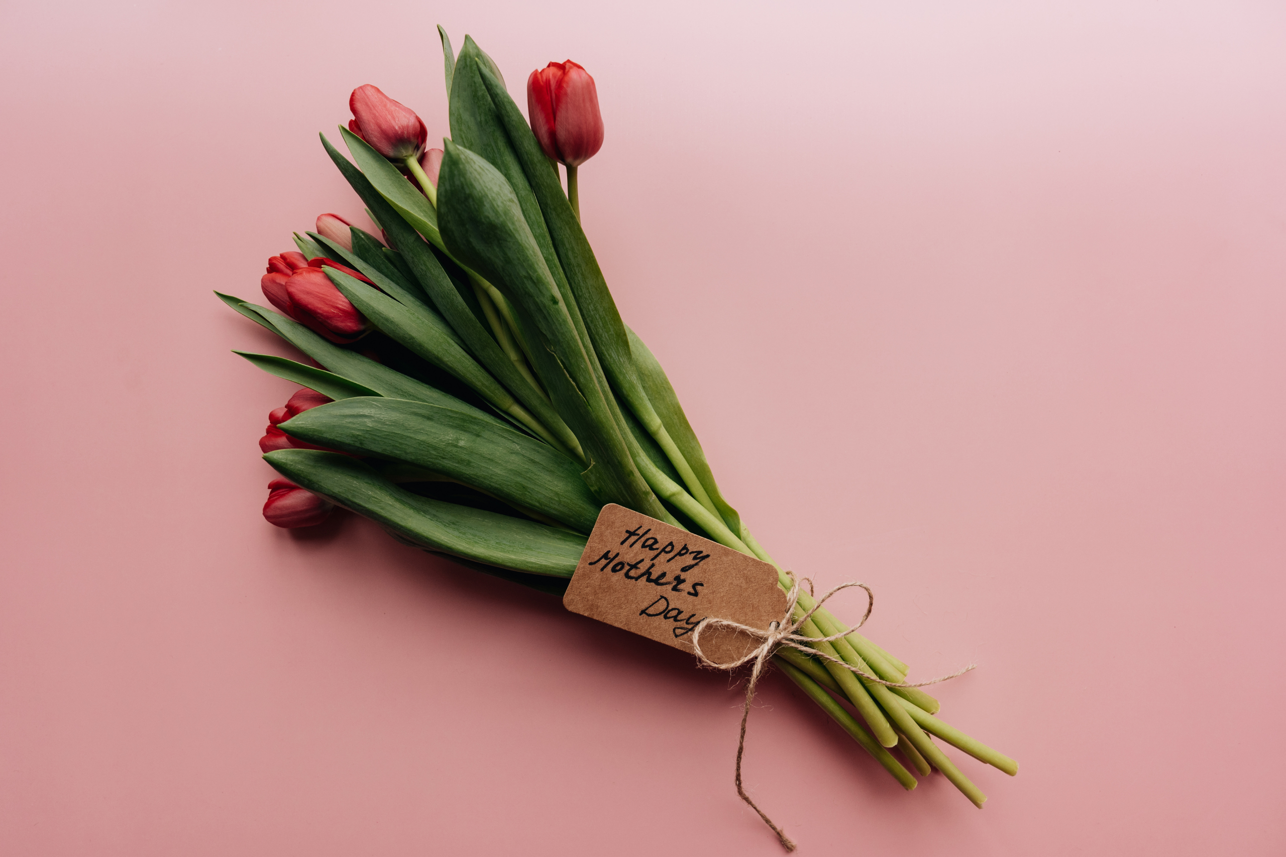 Bunch of pink tulips with a hand written Happy Mothers Day note