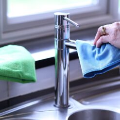 Cleaning faucet with blue cloth